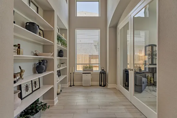 a view of a hallway with wooden floor and dining room