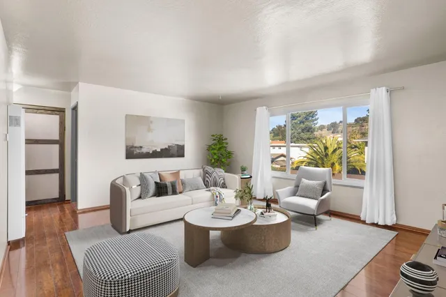 a living room with furniture and a large window