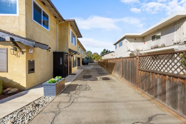 a view of a house with wooden fence