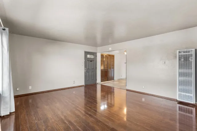 wooden floor in an empty room with a window