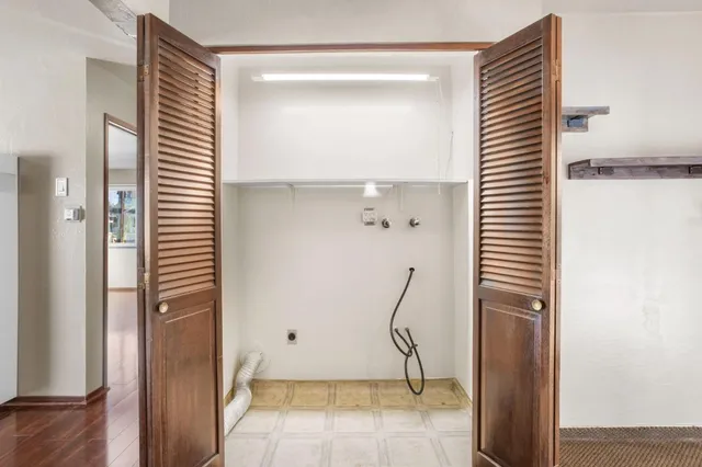 a view of room with stairs and a wooden floor