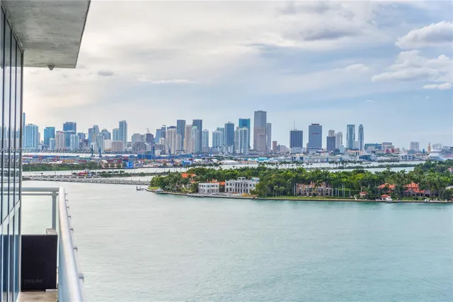 a view of a city with lake and tall buildings
