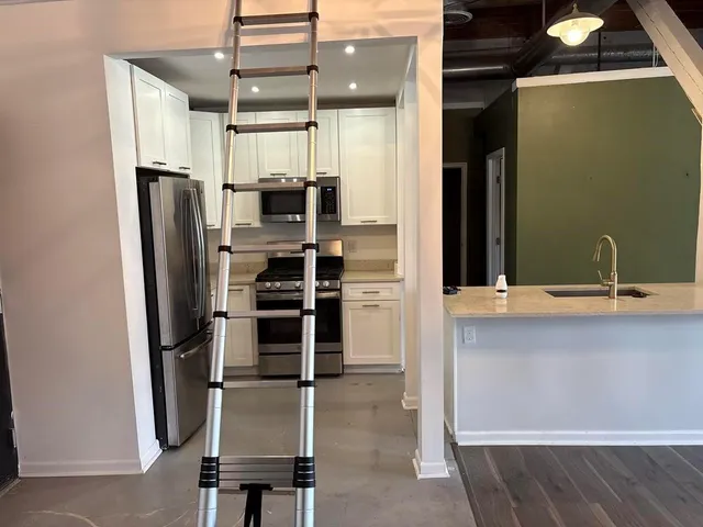 a kitchen with refrigerator and window