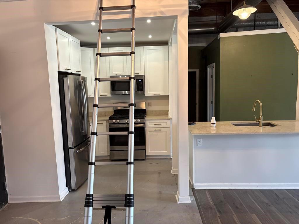 320 Martin Luther King Junior Drive Southeast, Unit 18A Atlanta, GA 30312 - Photo 5 of 15 a kitchen with refrigerator and window