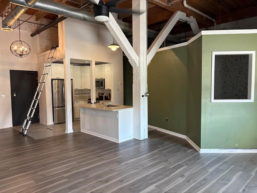 320 Martin Luther King Junior Drive Southeast, Unit 18A Atlanta, GA 30312 - Photo 7 of 15 a view of a hallway with wooden floor and staircase