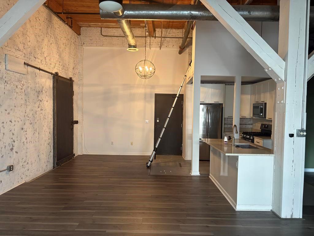 320 Martin Luther King Junior Drive Southeast, Unit 18A Atlanta, GA 30312 - Photo 8 of 15 a view of a hallway with wooden floor and staircase
