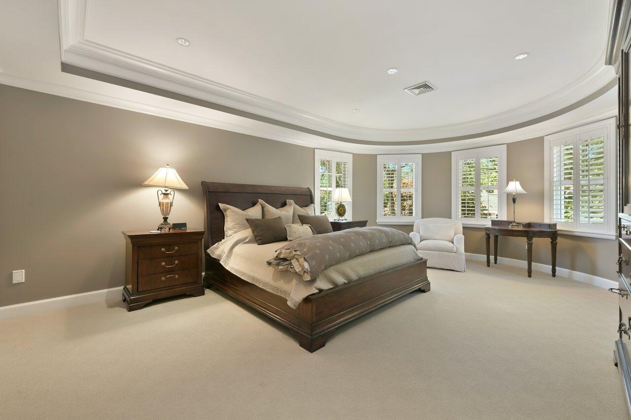 37 Shoestring Bay Road Mashpee, MA 02649 - Photo 25 of 42 a spacious bedroom with a bed and a lamp on table