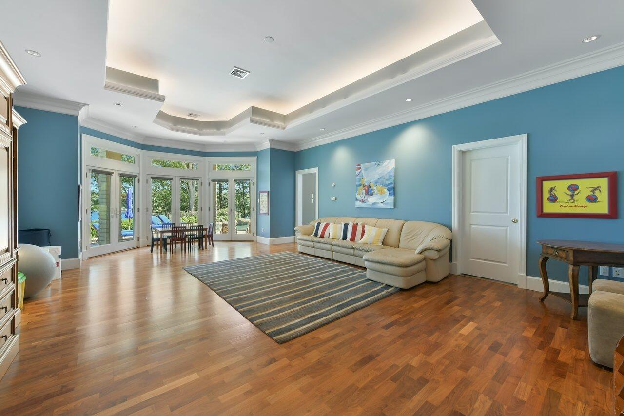 37 Shoestring Bay Road Mashpee, MA 02649 - Photo 32 of 42 a living room with furniture and a table with wooden floor