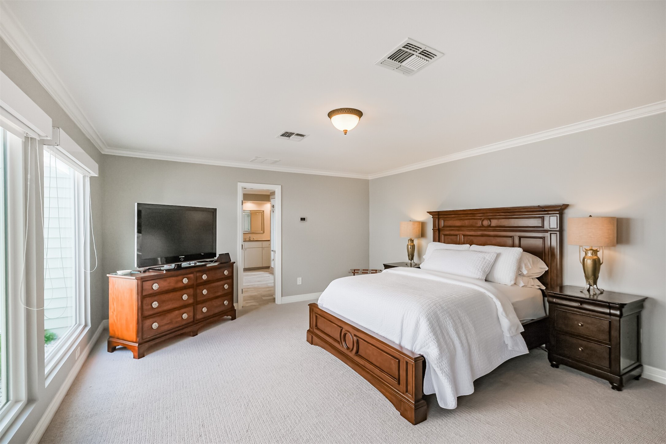 1007 Arrow Hill Road Houston, TX 77077 - Photo 22 of 48 The primary suite is very spacious with carpet floors and crown molding.