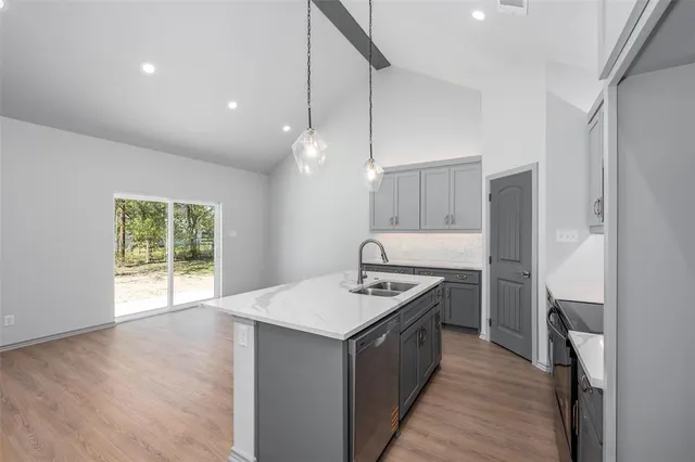 a kitchen with a stove a sink and a refrigerator