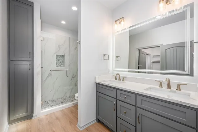 a bathroom with a granite countertop sink mirror and double