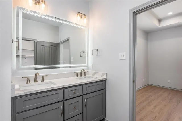 a bathroom with a double vanity sink and mirror
