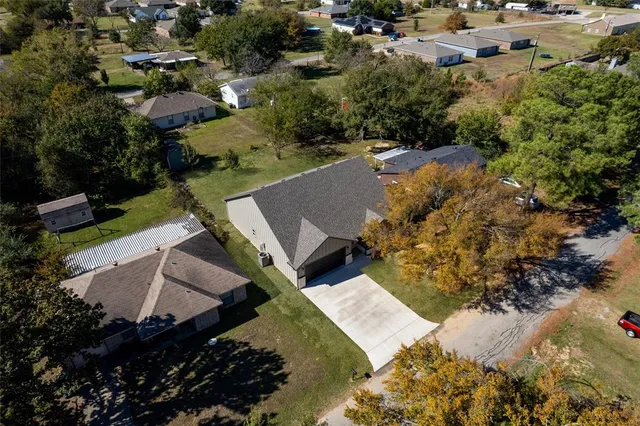 an aerial view of a house with a yard