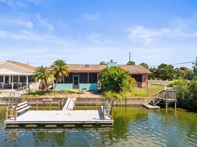a view of a swimming pool with a table and chairs