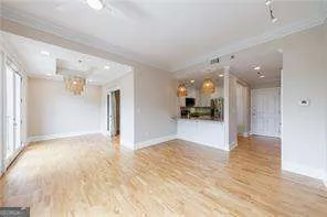 a view of a big room with wooden floor and a large window