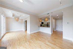 a view of a big room with wooden floor and a large window
