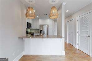 2255 Peachtree Road Northeast, Unit 620 Atlanta, GA 30305 - Photo 2 of 5 an view of dining room with wooden floor and living room