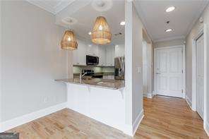 2255 Peachtree Road Northeast, Unit 620 Atlanta, GA 30305 - Photo 3 of 5 a view of kitchen with stainless steel appliances granite countertop living room