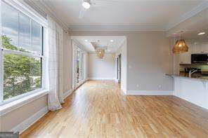 2255 Peachtree Road Northeast, Unit 620 Atlanta, GA 30305 - Photo 4 of 5 a view of empty room with wooden floor and fan