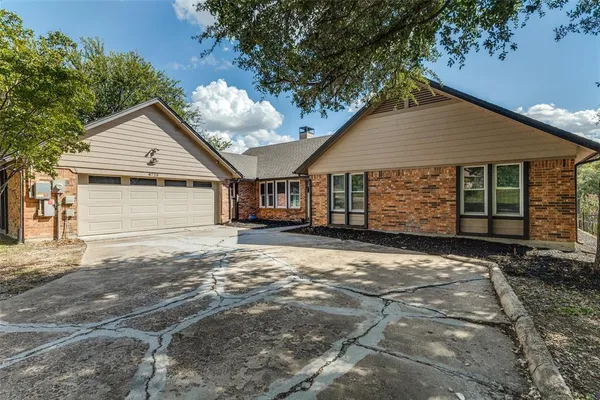 a view of a house with a yard and garage