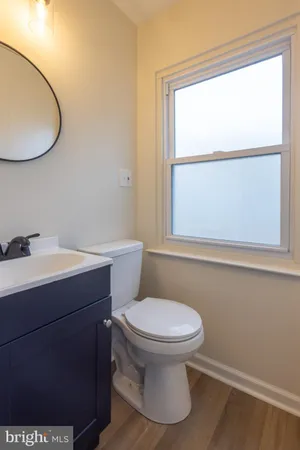 a bathroom with a toilet a sink and a window