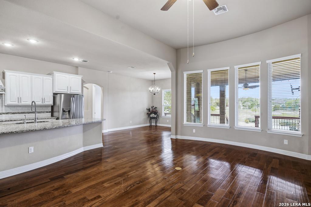 287 Cascade Trail Castroville, TX 78009 - Photo 11 of 46 a view of large kitchen with kitchen island wooden floor and stainless steel appliances