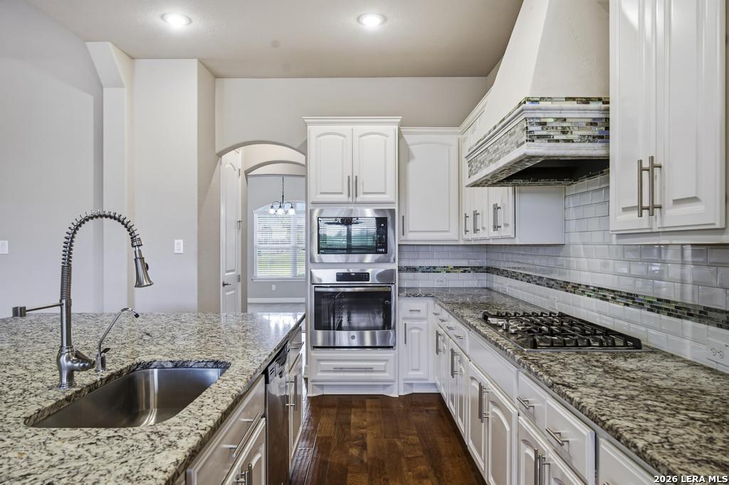 287 Cascade Trail Castroville, TX 78009 - Photo 14 of 46 a kitchen with a sink cabinets and stainless steel appliances