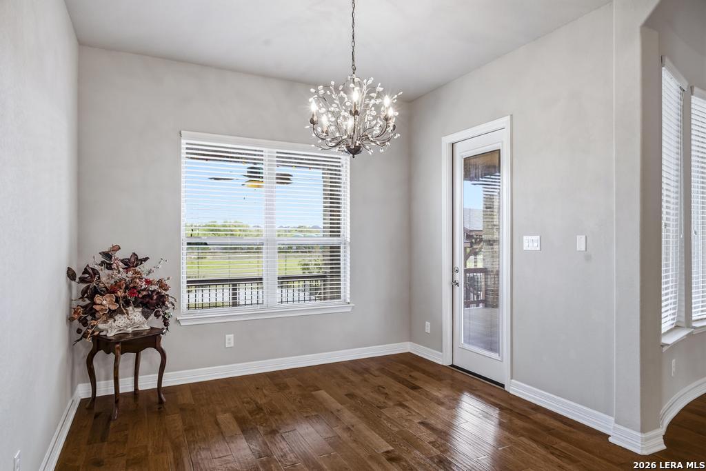 287 Cascade Trail Castroville, TX 78009 - Photo 16 of 46 a view of a room with wooden floor and a chandelier