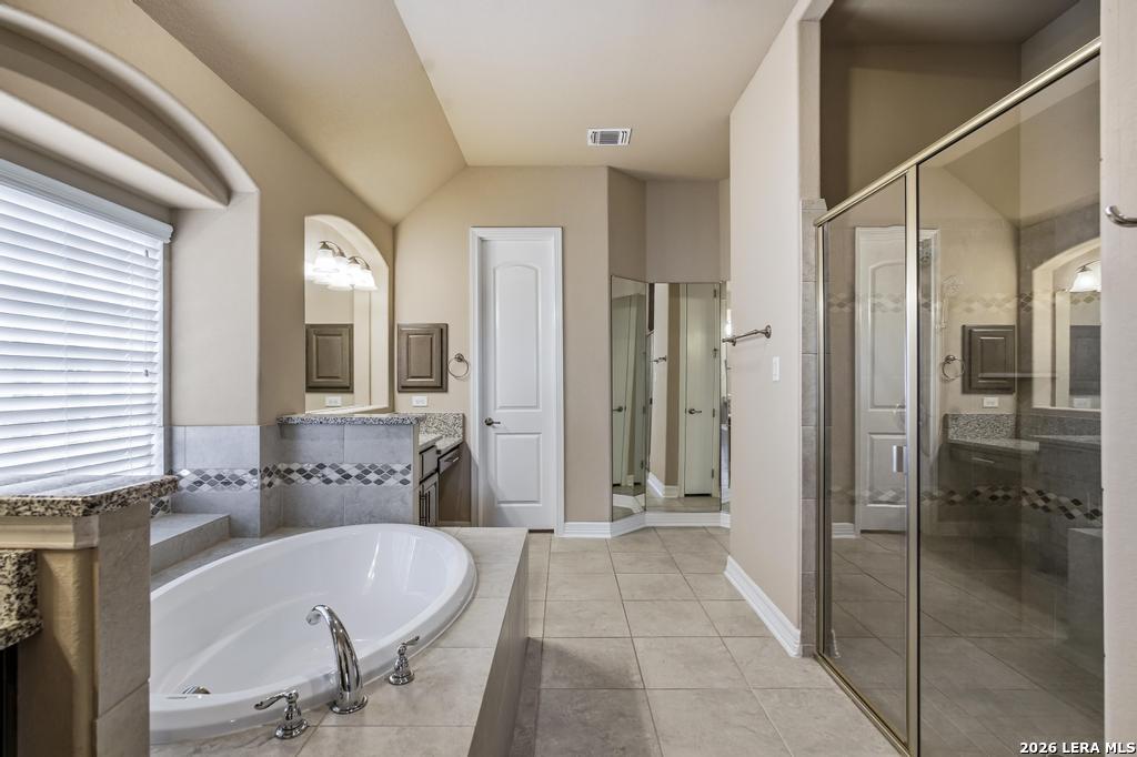 287 Cascade Trail Castroville, TX 78009 - Photo 20 of 46 a bathroom with a tub and shower