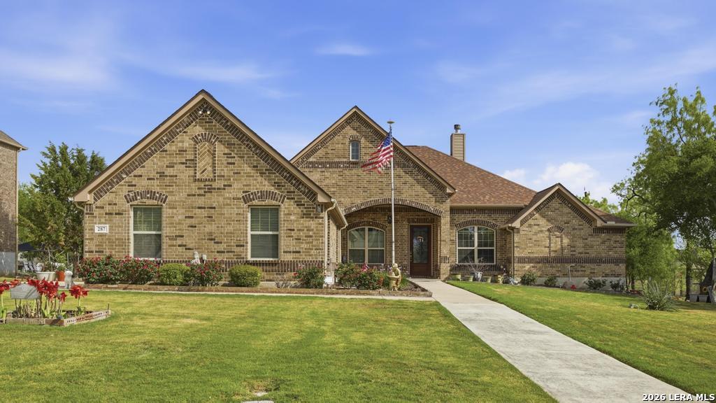 287 Cascade Trail Castroville, TX 78009 - Photo 2 of 46 a front view of house with yard and green space