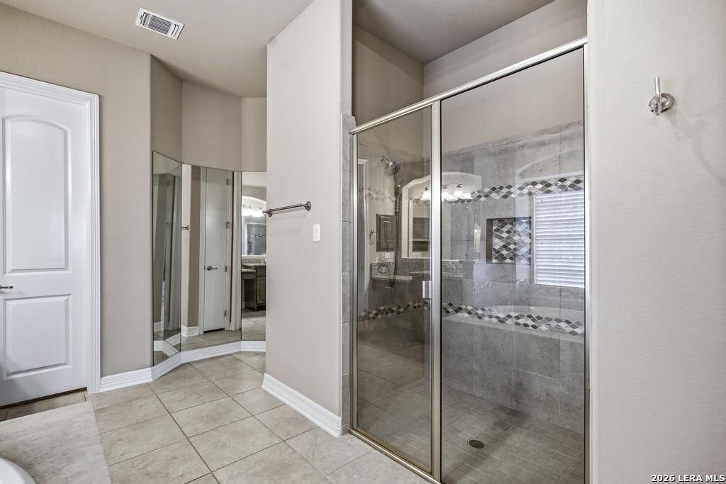 287 Cascade Trail Castroville, TX 78009 - Photo 21 of 46 a bathroom with a glass shower door