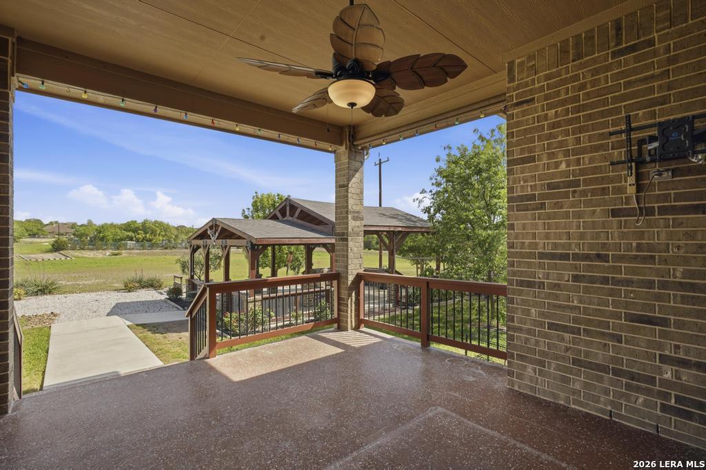 287 Cascade Trail Castroville, TX 78009 - Photo 34 of 46 a view of a balcony with floor to ceiling windows and garden view