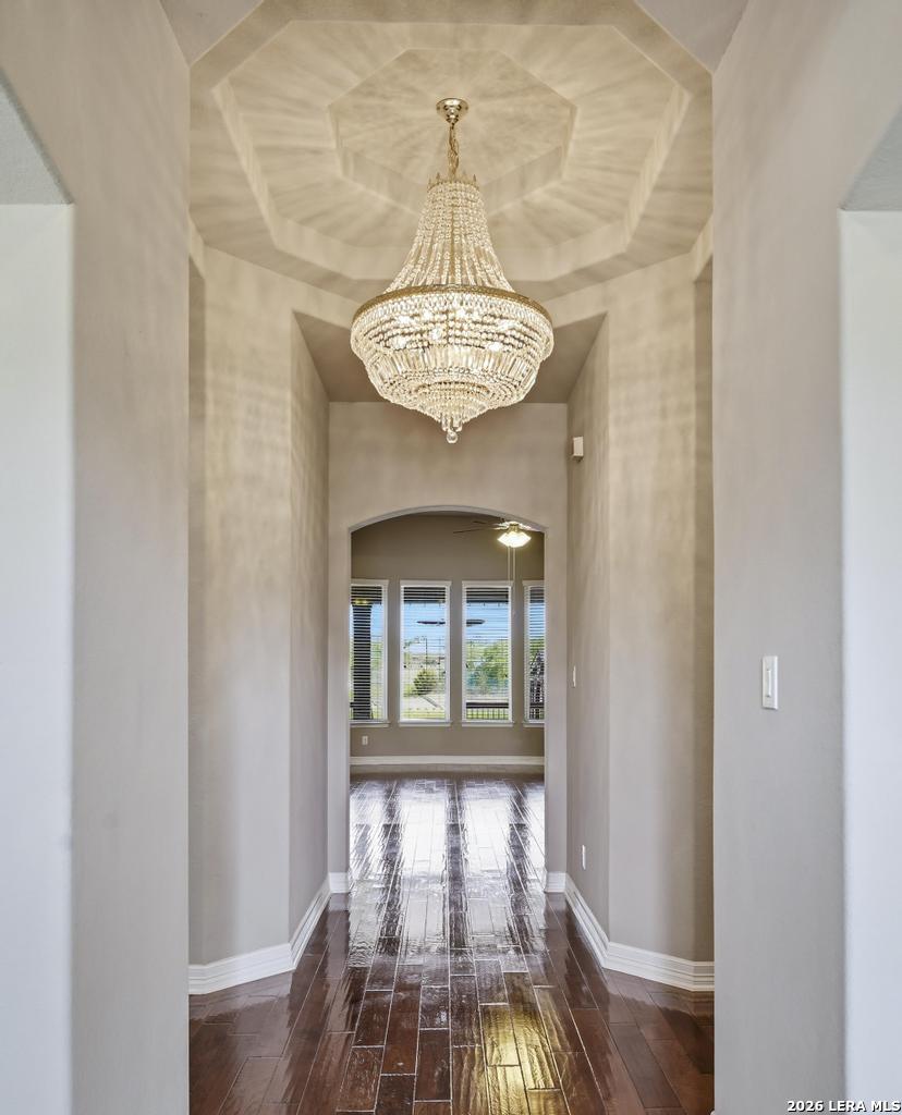 287 Cascade Trail Castroville, TX 78009 - Photo 4 of 46 a view of a room with a chandelier fan and wooden floor
