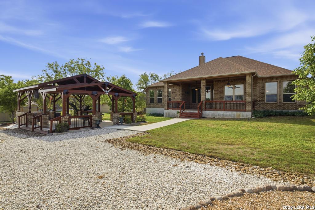 287 Cascade Trail Castroville, TX 78009 - Photo 42 of 46 a front view of a house with garden