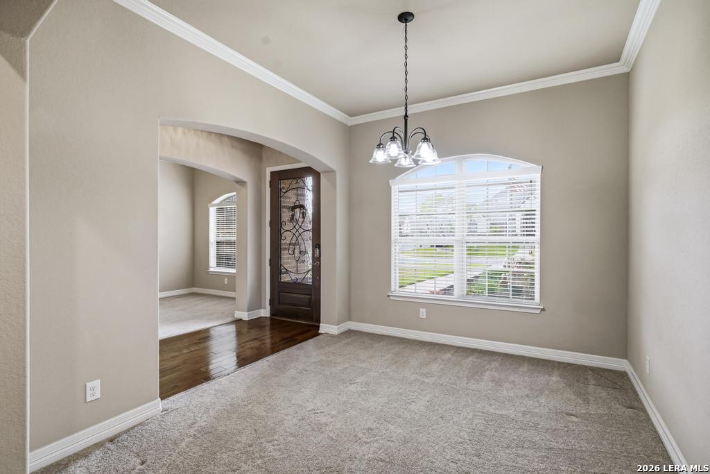 287 Cascade Trail Castroville, TX 78009 - Photo 5 of 46 a big room with windows and chandelier