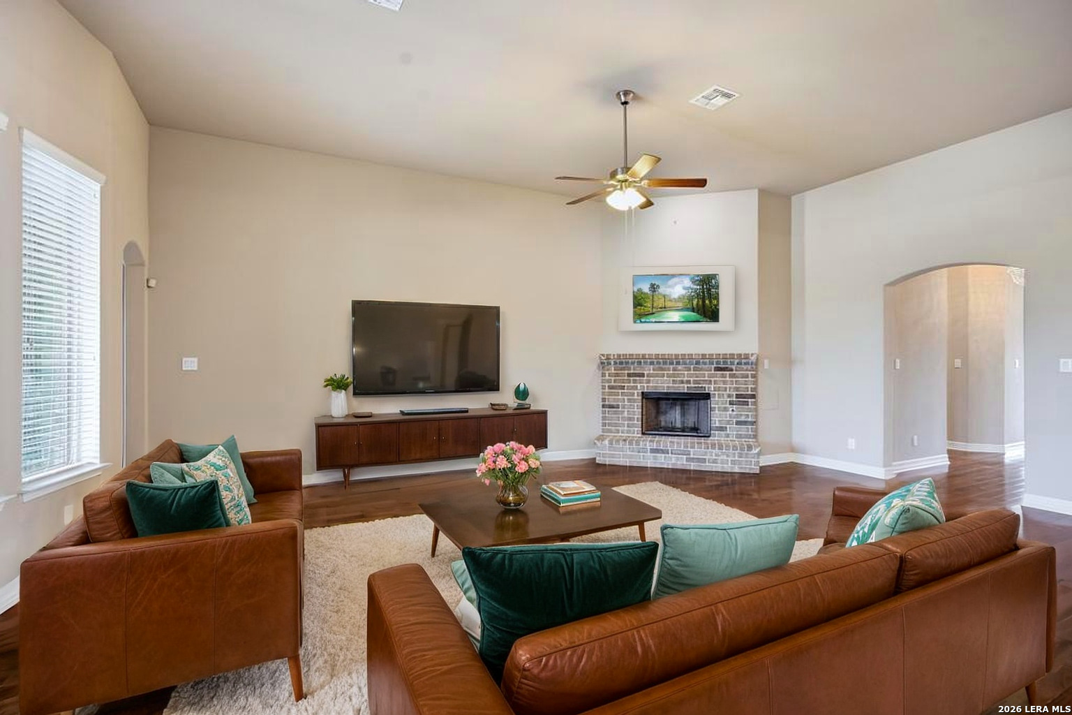 287 Cascade Trail Castroville, TX 78009 - Photo 9 of 46 a living room with furniture a flat screen tv and a fireplace