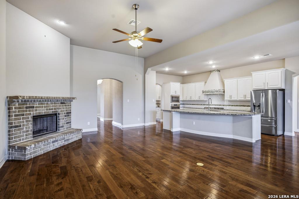 287 Cascade Trail Castroville, TX 78009 - Photo 10 of 46 a open kitchen view with fireplace a refrigerator and a fireplace