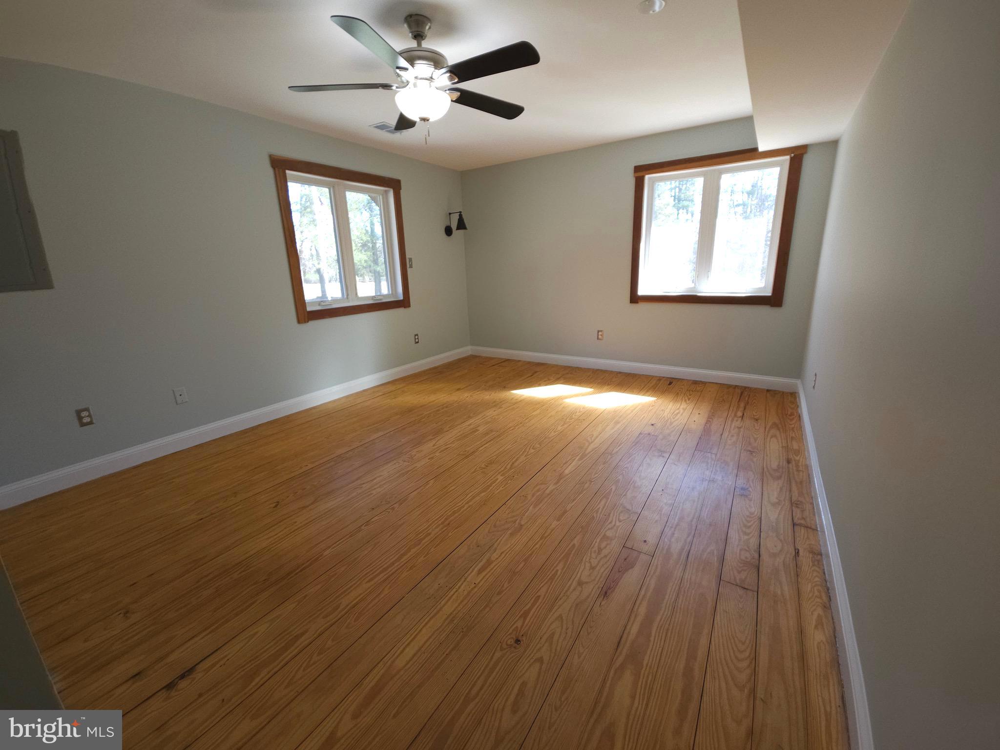 13256 Golden Drive Sumerduck, VA 22742 - Photo 18 of 27 a view of empty room with wooden floor and fan