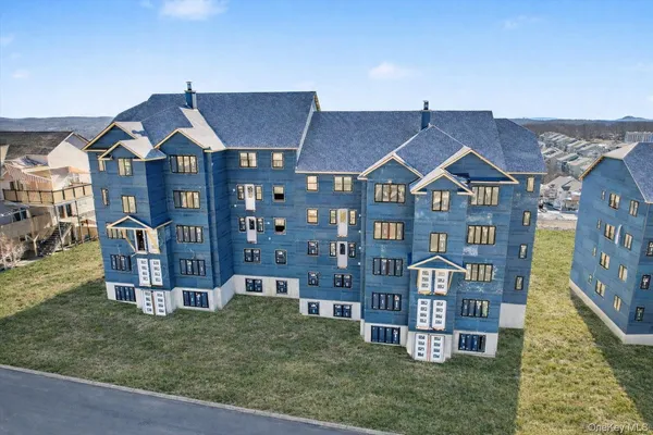 a front view of a residential apartment building with a yard