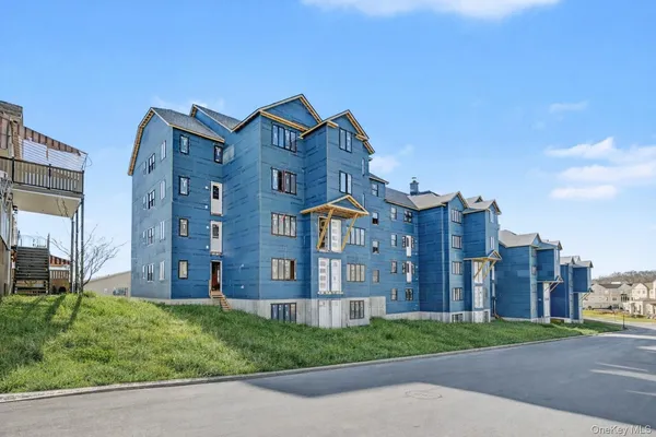 a view of a big building next to a yard