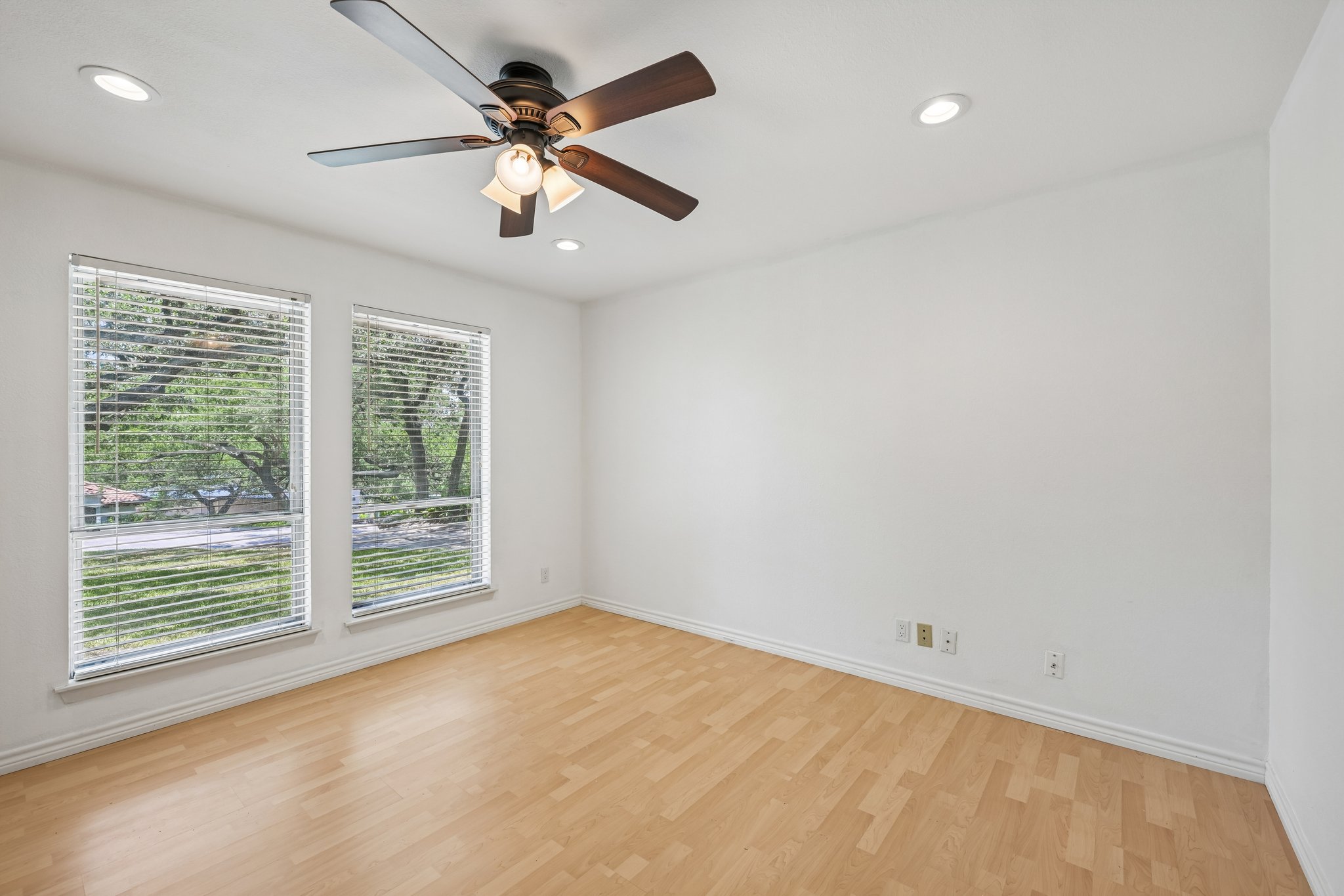 13101 Travis View Loop Austin, TX 78732 - Photo 10 of 27 Wood-looking floors and a ceiling fan create a comfortable atmosphere in this well-lit space.