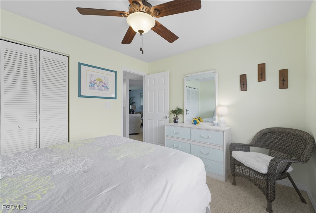 16881 Davis Road, Unit 126 Fort Myers, FL 33908 - Photo 11 of 27 a bedroom with a bed and a chandelier