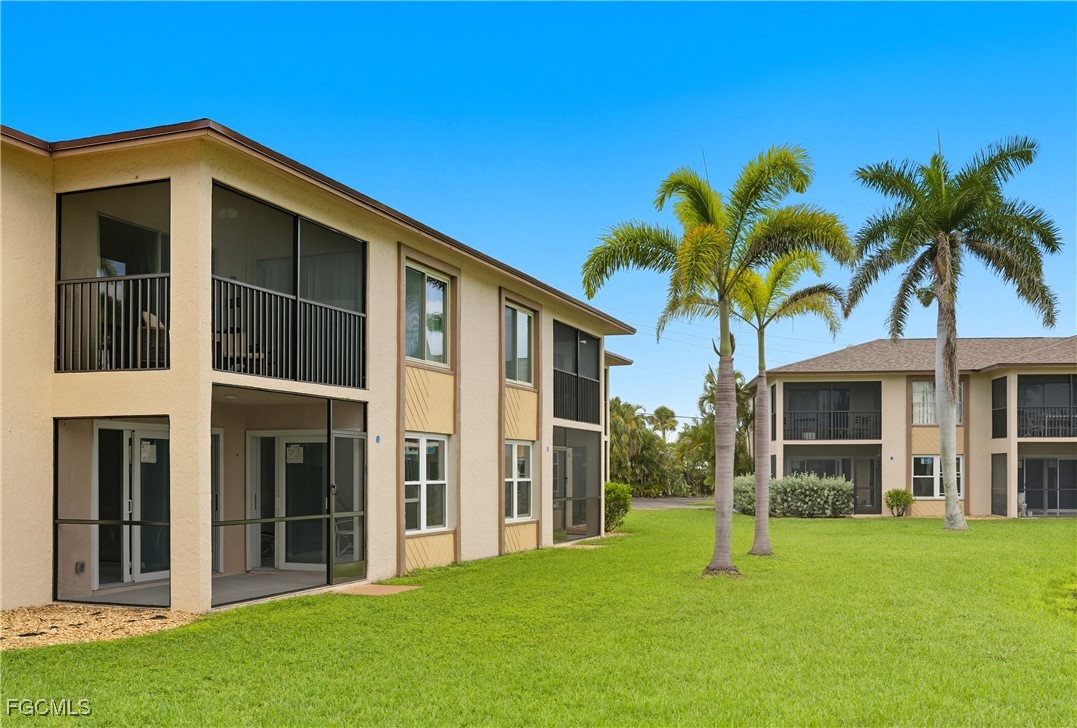 16881 Davis Road, Unit 126 Fort Myers, FL 33908 - Photo 23 of 27 a front view of a house with a yard