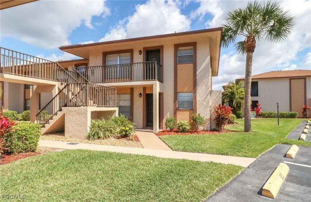 16881 Davis Road, Unit 126 Fort Myers, FL 33908 - Photo 25 of 27 front view of a house with a yard