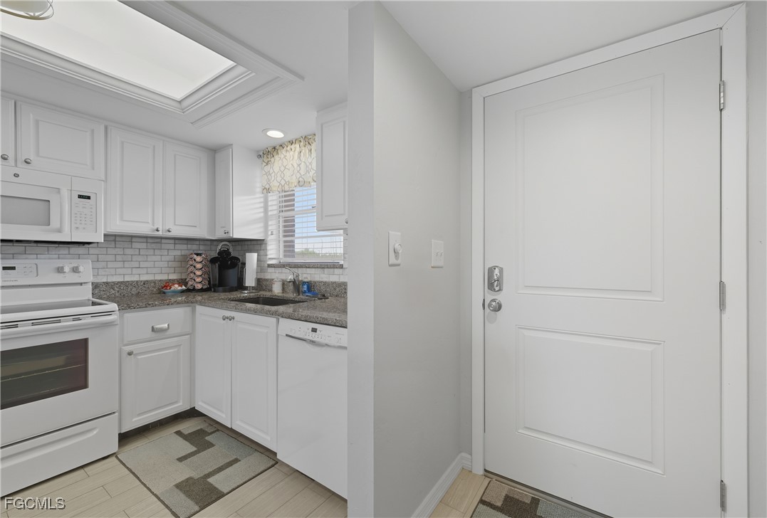 16881 Davis Road, Unit 126 Fort Myers, FL 33908 - Photo 3 of 27 a kitchen with cabinets appliances and a window