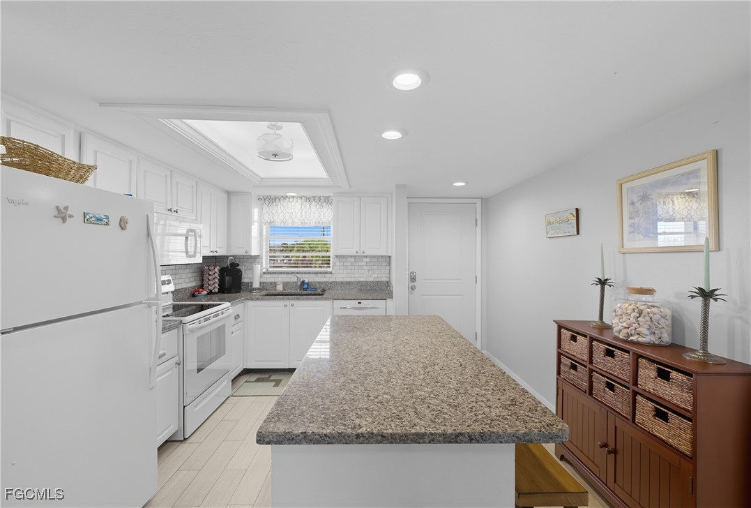 16881 Davis Road, Unit 126 Fort Myers, FL 33908 - Photo 5 of 27 a kitchen with stainless steel appliances granite countertop a sink stove and refrigerator