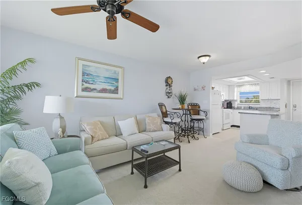 a living room with furniture and kitchen view