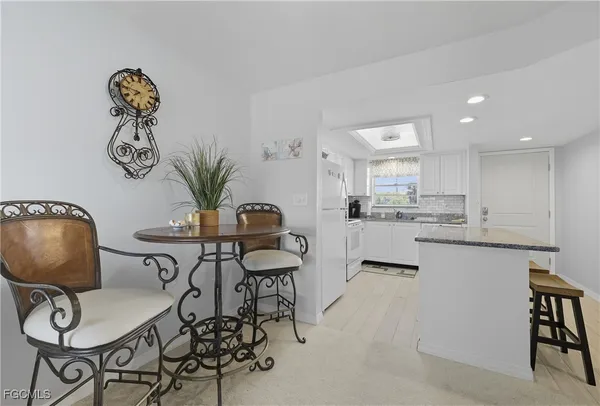a view of kitchen with cabinets and dining table
