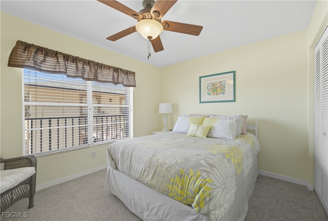 16881 Davis Road, Unit 126 Fort Myers, FL 33908 - Photo 10 of 27 a bedroom with a bed and a large window
