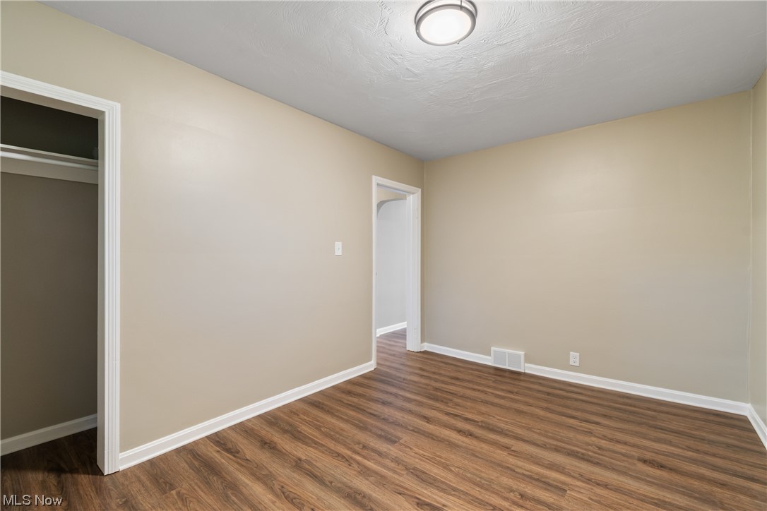 916 Renninger Road Akron, OH 44319 - Photo 21 of 31 Unfurnished bedroom featuring a closet and dark wood-type flooring